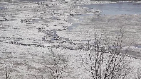 River spring ice breakup ice jams is ice walking on ice is dangerous Stock Footage 71668299