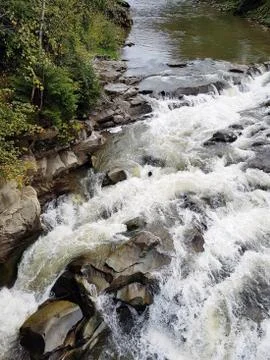 River stone rapids in the spring. Filled river mountain stream. Stock Photos