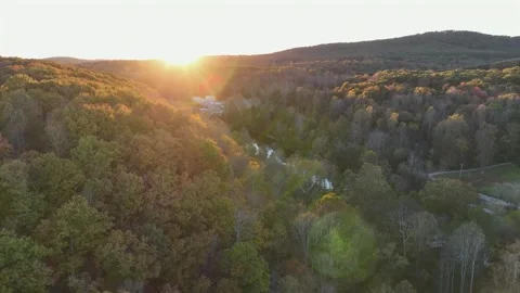 River stream between colored trees in autumn. Aerial wide shot. Sunset time Video stock 321446747