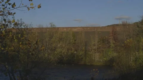 River stream, brick building, cross in background, foliage Stock Footage 304373483
