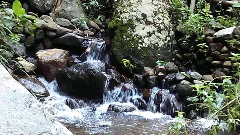 River stream crossing rocks which are stacked into many small waterfalls Video stock 124942889