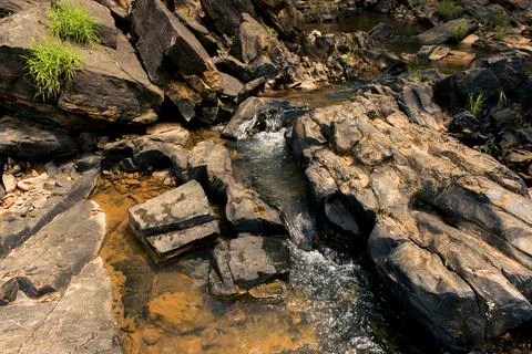 River stream flowing between the black rocks,Yellapur,India Stock Photos