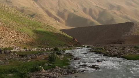As the river stream meanders through a rocky path waves, stock footage. Stock Footage 304784547