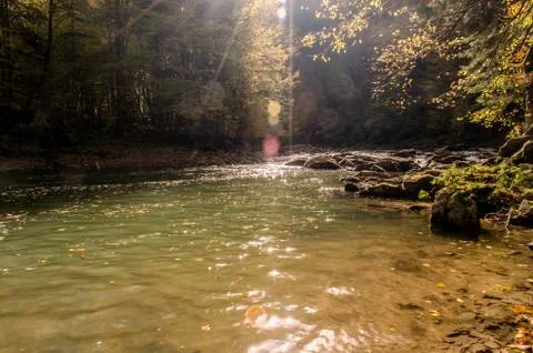 River in the sun and clouds Stock Photos
