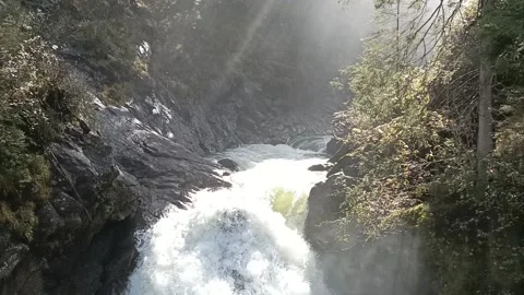 River in the sun descending into waterfall Stock Footage 218166626