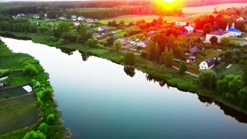 River at sunset in a city park with clouds reflecting in the water Video stock 155837697