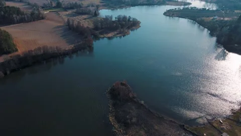 River at sunset in a city park with clouds reflecting in the water Video stock 155955495