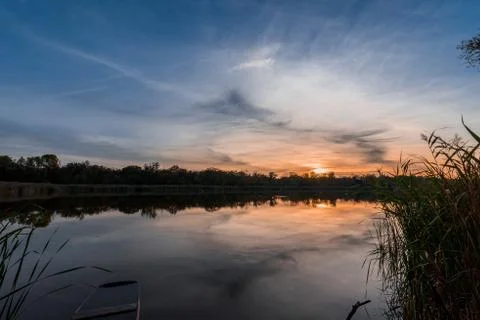 The river at sunset, the mirror surface of the water Stock Photos