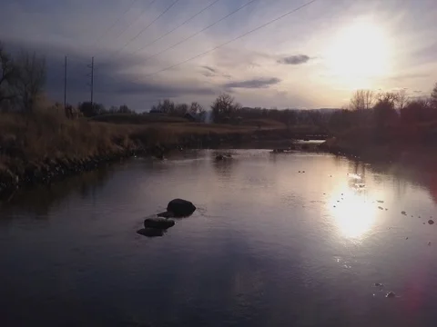 River sunset pull back over small rapids Stock Footage 73533095