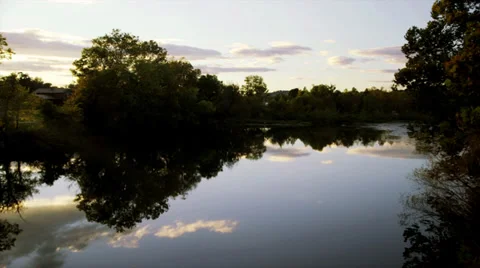 River at sunset - right to left pan w/sun flare Stock Footage 32065271