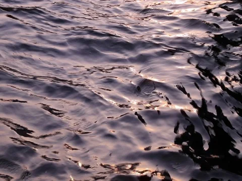 The river surface and sun glare on the water at sunset on a cloudy day. Stock Footage 129761745
