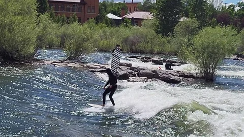 River Surfer riding rapids at Brennan's Wave, Clark Fork River Missoula 스톡 동영상 340242601