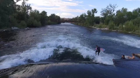 River Surfing 4k Aerial Pull Back Stock Footage 100090499