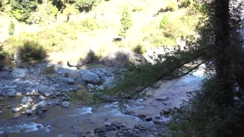 River surrounded by mountains in the middle of the valley, flowing against t 動画素材 223185996