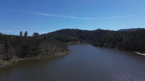 A river surrounded by trees and mountains Video stock 328615661