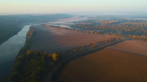 A river surrounded by trees and plowed fields. Stock Footage 114431103