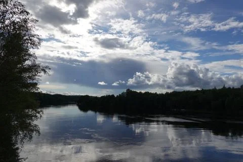 River in Sweden with reflection of the clouds in the water Stock Photos
