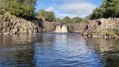 The River Tees at Low Force waterfalls in early Autumn, England, UK Stock Footage 287476342