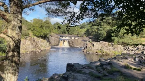 The River Tees at Low Force waterfalls in early Autumn, England, UK Stock Footage 287476440