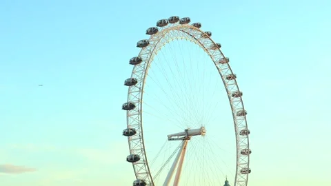 The River Thames and London Eye on a bright blue sky day in London Stock Footage