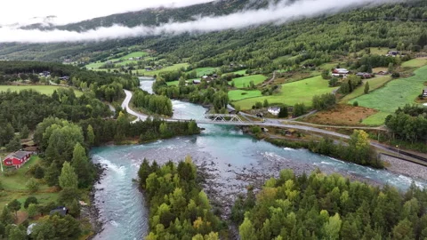 River through Green Fields in a Valley Stock Footage 346665514