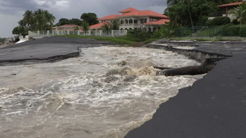 River, torrent flowing into the ocean on a beach with a large luxury house. Stock Footage 159085055