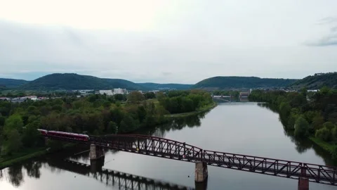 A river with a train bridge from above Stock Footage 154487072