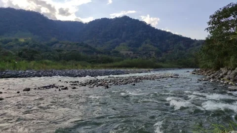 River with trees and mountains in the background in Peru Stock Footage 282217477