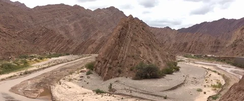 River turning in a deserted valley with small mountain in the middle Video stock 90662496
