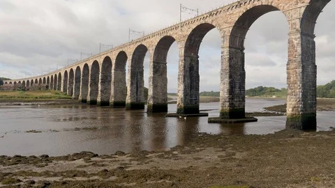 River Tweed at low tide flows under iconic Royal Borders Bridge-England Stock Footage 96496548