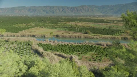 River valley covered by green fields with the mountains on the background. 4k Stock Footage 58732091