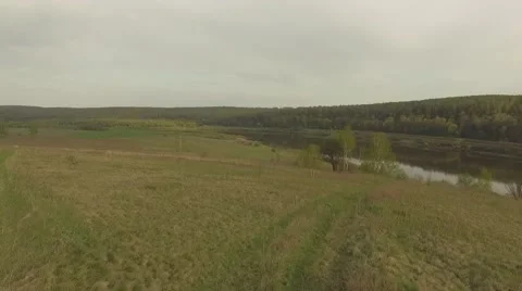 River valley with a field in spring Aerial shot Видео 69068492