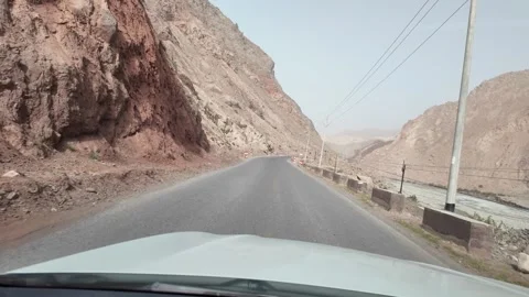River Valley Road Through Barren Mountains in Southern Xinjiang China Stock Footage 339805076