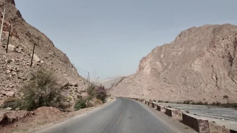 River Valley Road Through Barren Mountains in Southern Xinjiang China Stock Footage 339805149