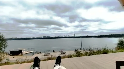 River view and city skyline from wooden waterfront, calm POV Stock Footage 319435717