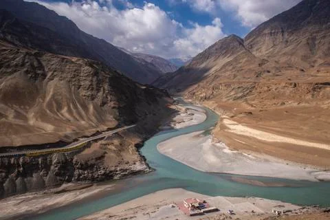 River view and mountain range against blue sky with clouds Foto stock