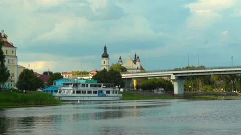 River view with boat and buildings near the bridge in a town during the afternoo Video stock 340448009