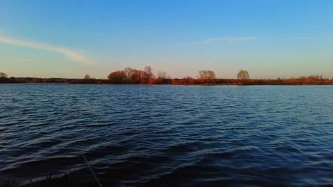 River view with trees and water under clear sky at sunset in autumn Stock Footage 333440522