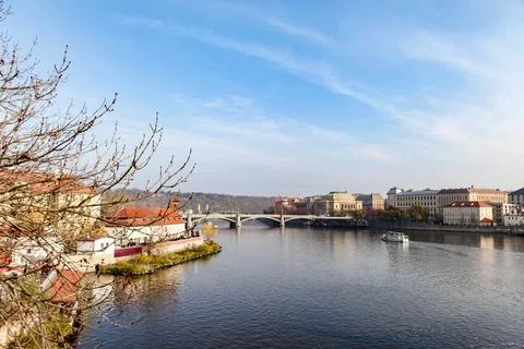 A river Vltava runs through a city in Prague Czech Republic with a bridge o.. Stock Photos