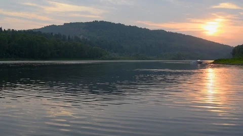 The river in the warm rays of the setting sun with the reflection of the sky Stock Footage 92235564