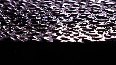 River of water drops on black surface above black background Stock-Footage 78351923