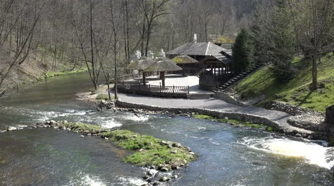 River water fall near empty resort with straw arbor. 4K Stock Footage 51608392