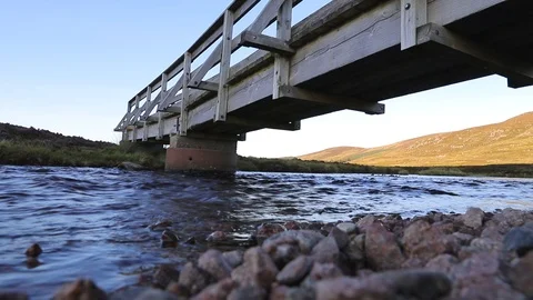 River water flow. Water flows in the river against a green mountain landscape. Stock Footage 121396412