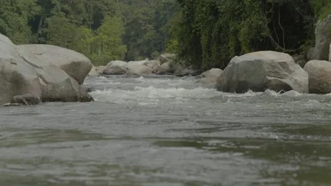 RIVER WATER FLOWING BETWEEN ROCKS-(HD) Stockbeeldmateriaal 145355913