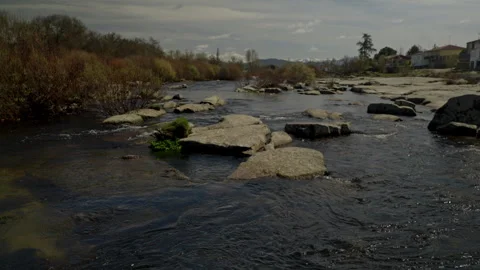 River water flowing gently over large granite rocks Stock Footage 335462735