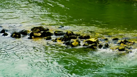 River water flows over stone made barrier Stock Footage 140430230