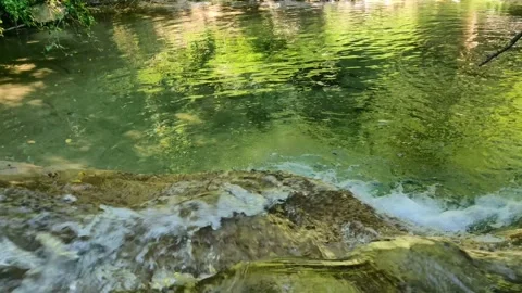 The river water flows into the puddle of water Stock Footage 136977690