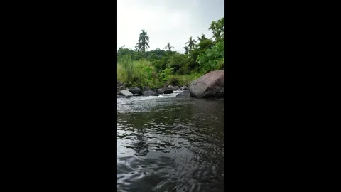 River water flows softly over smooth stones. Ideal for nature documentaries, 스톡 동영상 334628149