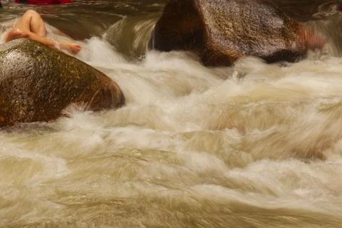 River water flows through rocks. Stock Photos