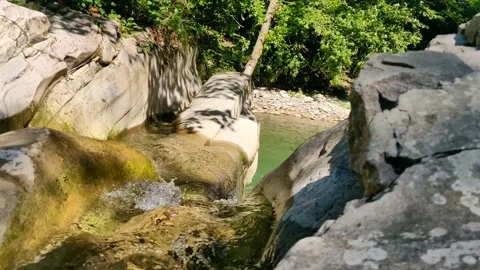 The river water forms a small waterfall Stock Footage